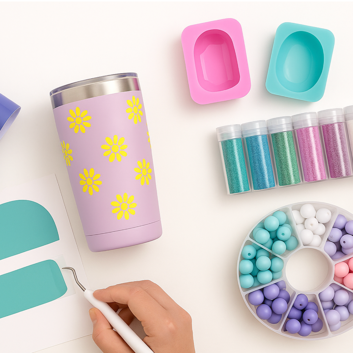Colorful art supplies including a tumbler, paint containers, and a color wheel on a white background.