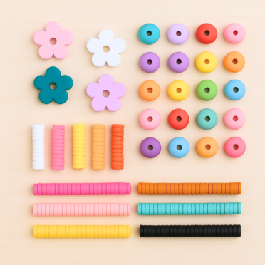 Colorful beads and flower-shaped objects on a beige background