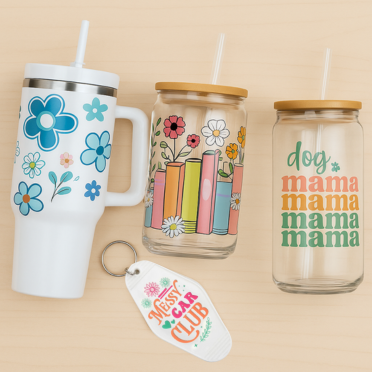 Set of three drinkware items with floral and text designs on a beige background
